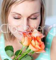 Smiling woman smelling roses