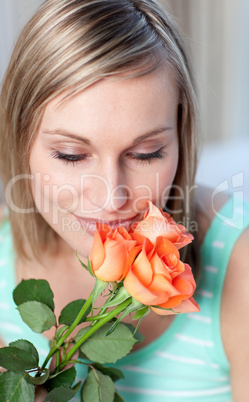 Charming woman smelling roses