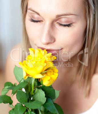 Attractive woman smelling roses