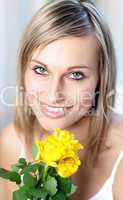 Portrait of a bright woman holding yellow roses