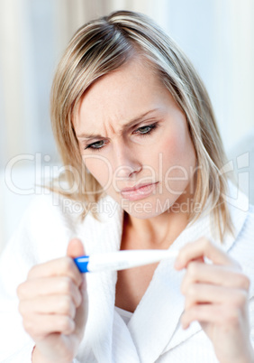 Worried woman finding out the results of a pregnancy test