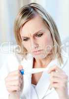 Worried woman finding out the results of a pregnancy test