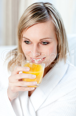 Portrait of a young woman holding an orange juice