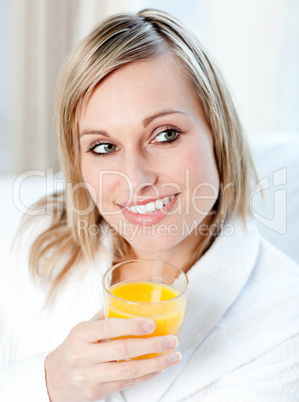 Portrait of a charming woman holding an orange juice
