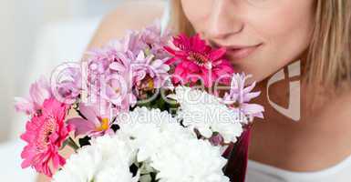 Close-up of a woman smelling a bunch of flowers