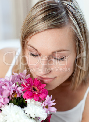 Beautiful woman smelling a bunch of flowers