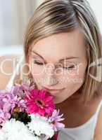 Beautiful woman smelling a bunch of flowers