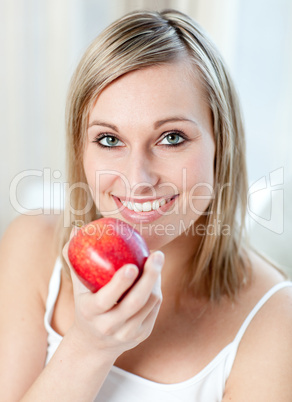 Smiling woman eating an apple