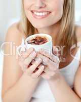 Portrait of a smiling woman drinking a coffee