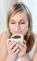 Portrait of a delighted woman drinking a coffee
