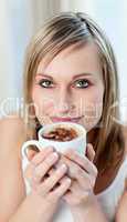 Portrait of a cheerful woman drinking a coffee