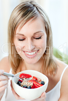 Bright woman eating muesli with fruits