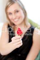 Jolly woman eating a strawberry