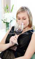 Charming blond woman drining red wine