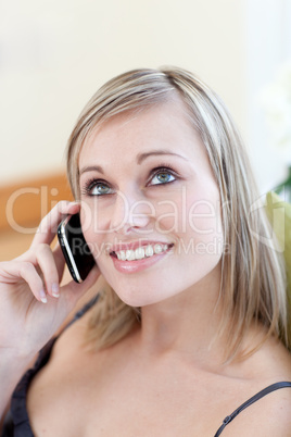 Attractive woman talking on phone sitting on a sofa