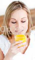 Portrait of a beautiful woman holding an orange juice