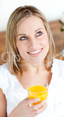 Portrait of a radiant woman holding an orange juice