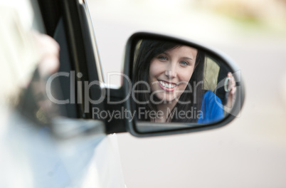 Attractive teen girl sitting in her car holding keys