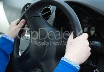 Close-up of woman's hands on the wheel