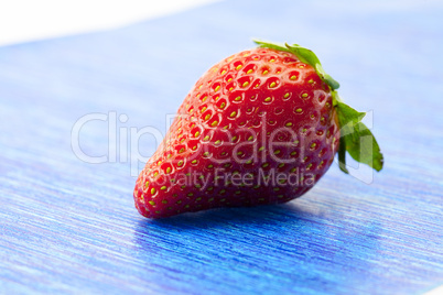 Strawberries on blue paper