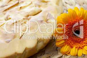 apple pie and a flower on a wicker mat