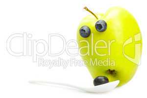 joke apple with eyes and a spoon with blueberries isolated on wh