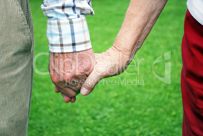 senior couple holding hands