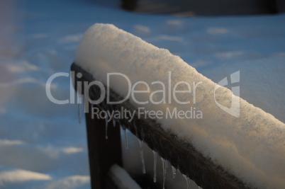 snow on arm of chair