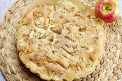 home apple pie and apple on a wicker mat