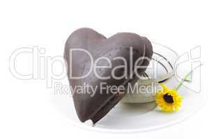 cake in the form heart and flower on a plate isolated on white