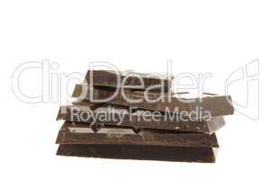 mountain of pieces of chocolate isolated on white