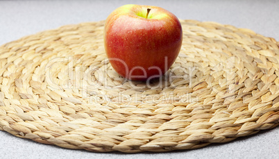 apple on a wicker mat