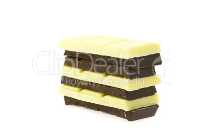 mountain of white and dark chocolate isolated on white