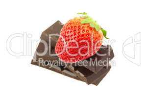 Strawberry on the mountain of chocolate isolated on white