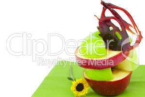 sliced apples with caramel and a flower on a napkin