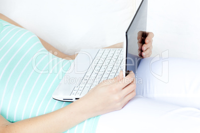 Close-up of a woman surfing the internet lying on a sofa
