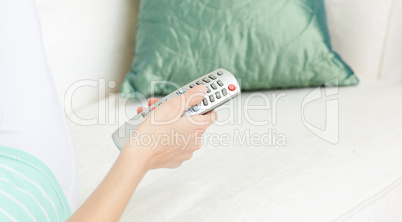 Cllose-up of a Caucasian woman holding a remote