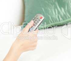 Cllose-up of a woman holding a remote