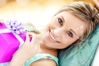 Cheerful woman holding a present
