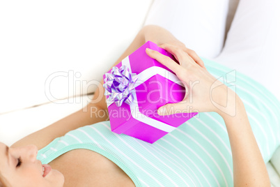 Charming woman holding a present