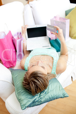 Beautiful woman shopping on-line at home