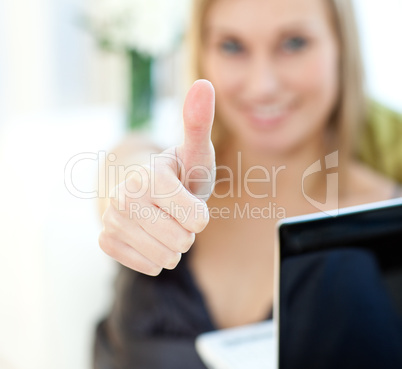 Close-up of a woman surfing the internet sitting on a sofa