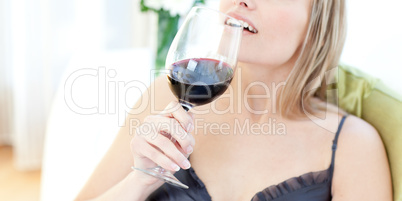 Blond woman drinking red wine