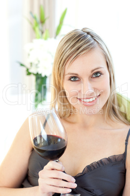 Jolly woman drinking red wine