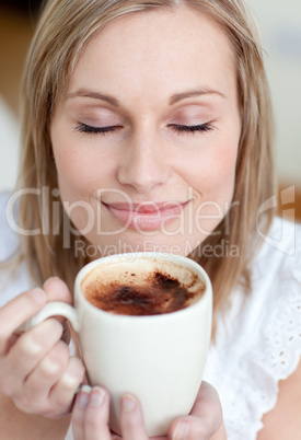 Delighted woman drinking a coffee