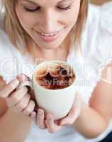Radiant woman drinking a coffee
