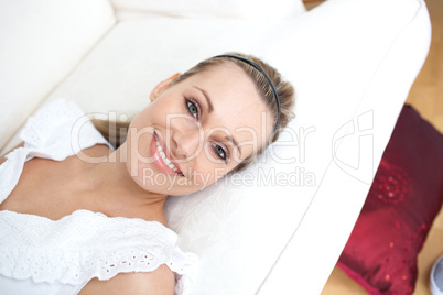 Attractive woman lying on sofa