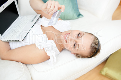Charming blond woman shopping on-line at home
