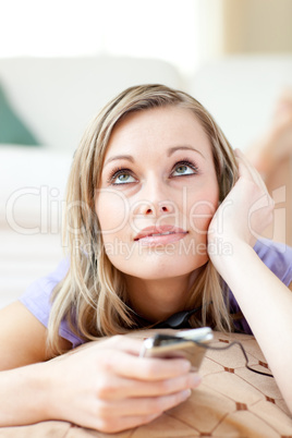 Attractive woman listening music lying on the floor