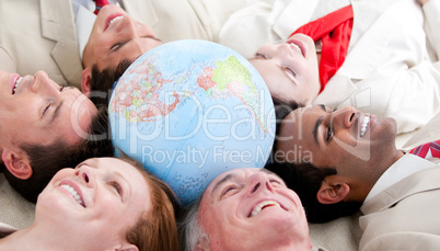 Multi-ethnic business people lying around a globe